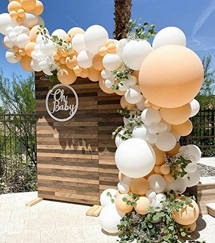 Balloon arch with 'Oh Baby' sign at outdoor event.