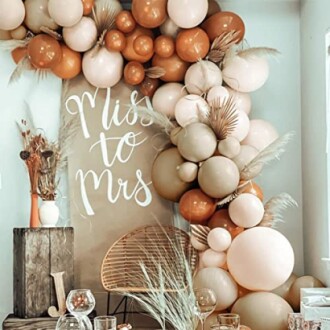 Bridal shower decor with balloons and 'Miss to Mrs' sign.