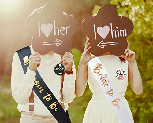 Bride and groom holding signs with arrows pointing to each other.