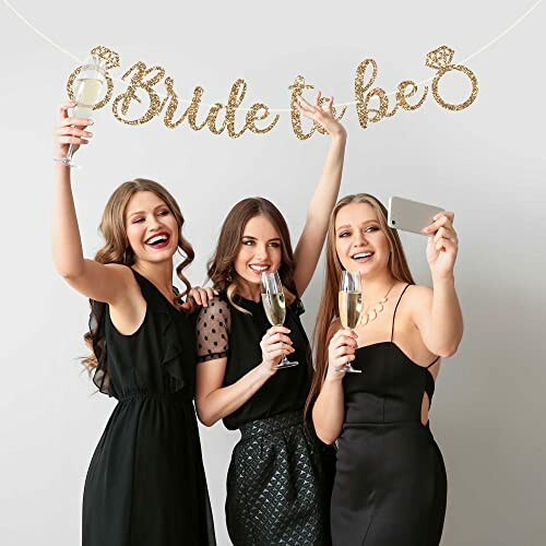 Three women celebrating with 'Bride to be' banner and champagne.