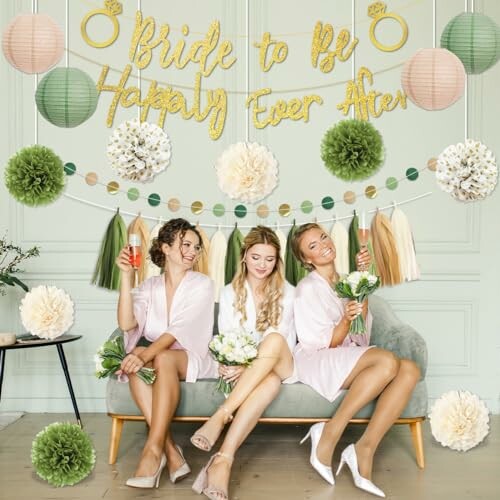 Three women at a bridal shower with decorations and drinks.