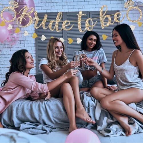 Four women celebrating a bride-to-be party with champagne.