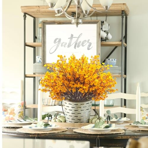 Dining table with autumn floral centerpiece and 'gather' sign.