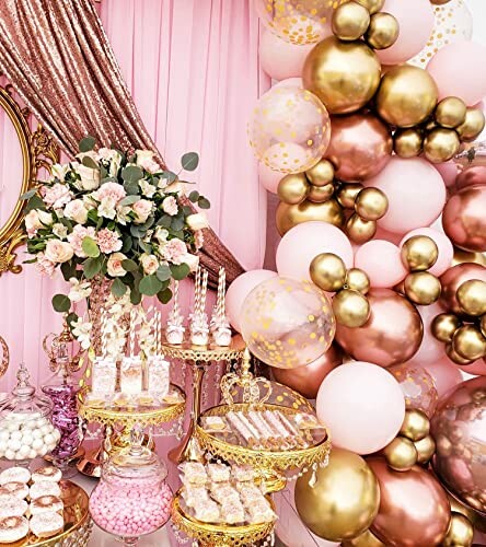 An elegant party decor with pink and gold balloons, floral arrangements, and dessert trays, featuring the Beaumode Balloon Garland Arch as the centerpiece.