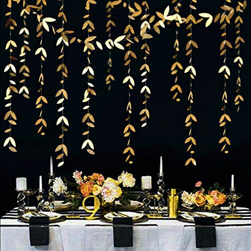 Elegant party table with floral centerpiece and hanging gold decorations.