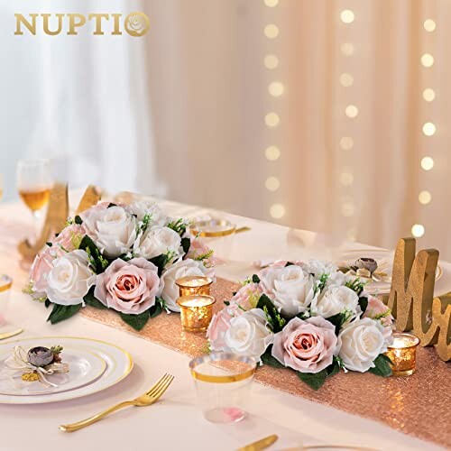 Elegant wedding table with rose bouquets and candles.