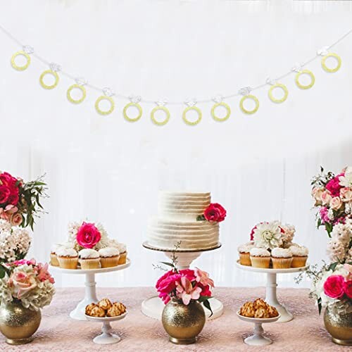 Elegant dessert table with cake, cupcakes, and floral decorations