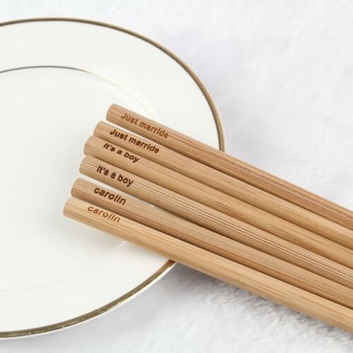 Engraved chopsticks with text on a plate.