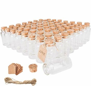 Set of small glass bottles with cork stoppers and tags.