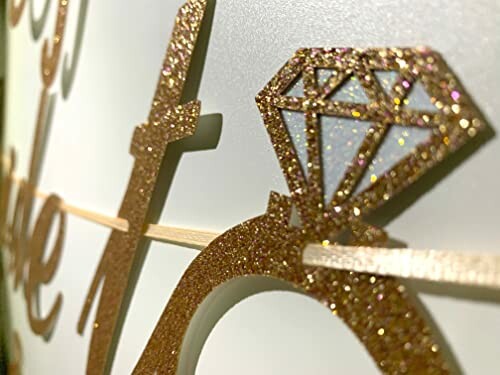 Close-up of a glittery diamond ring decoration on a surface.