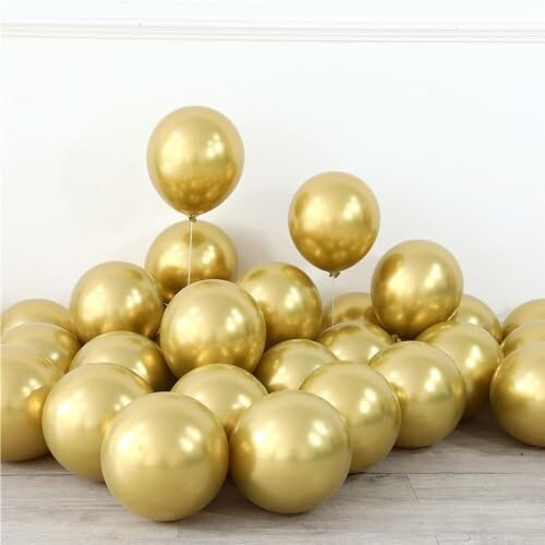 Pile of shiny gold balloons on the floor.