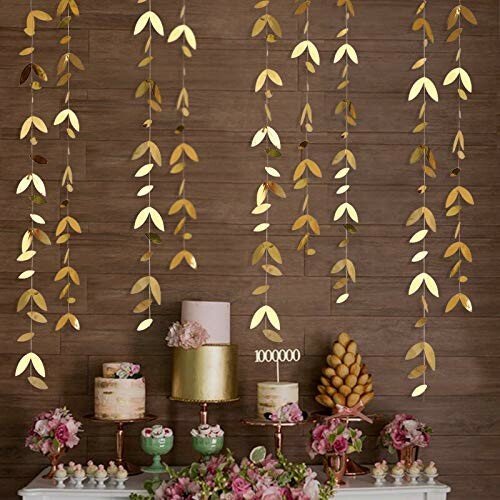 Gold leaf hanging decor with cakes and flowers on a table