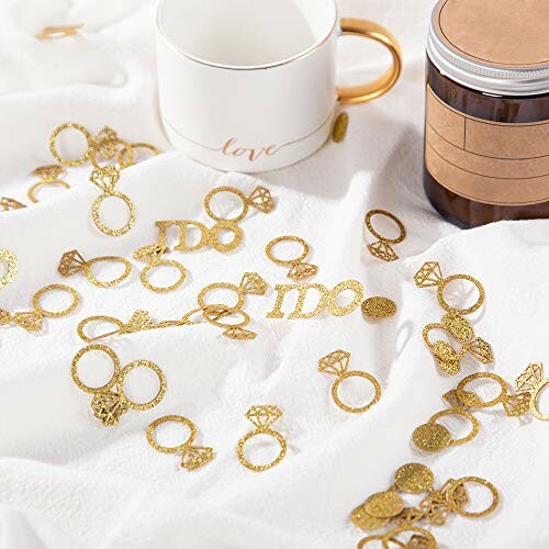 Gold wedding ring confetti with mug and jar, perfect for a wedding party or engagement party decoration.