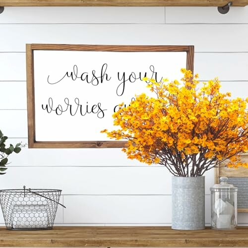 Decorative sign reads 'wash your worries away' with flowers.