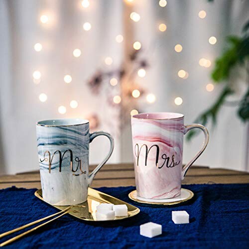 Mr. and Mrs. mugs on a table with decorative lights