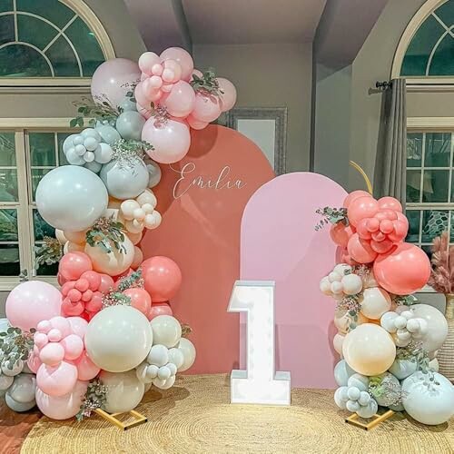 Pastel balloon arch with a large number one decoration.