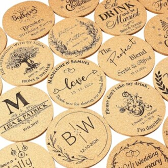 Assorted personalized wedding coasters with various designs and text.