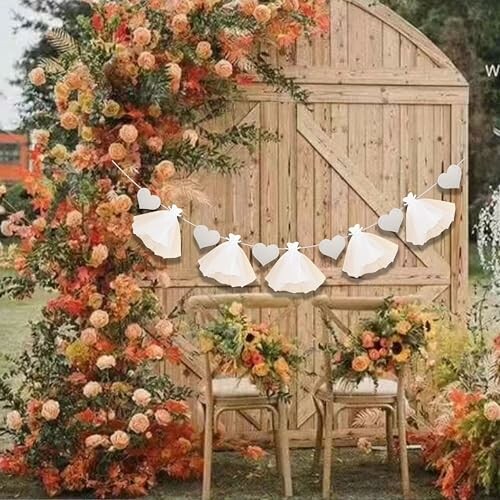 Rustic outdoor wedding setup with autumn flowers and wooden backdrop.