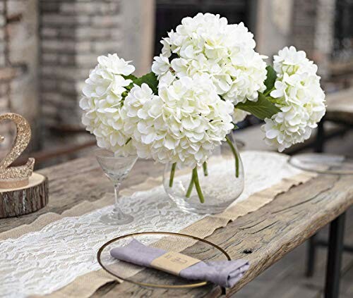 Rustic table setting with white flowers in a vase.