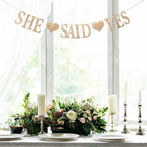 She Said Yes banner above a decorated table with flowers and candles