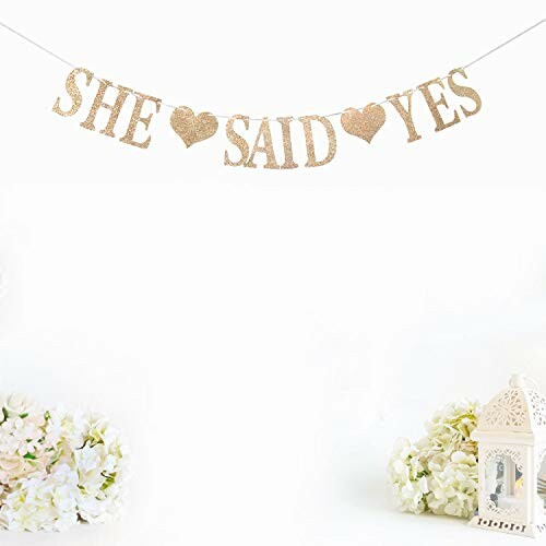 She Said Yes banner with flowers and lantern