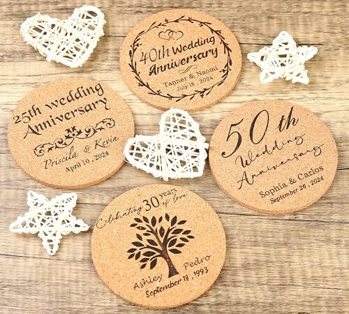 Cork coasters with wedding anniversary engravings and decorative hearts.