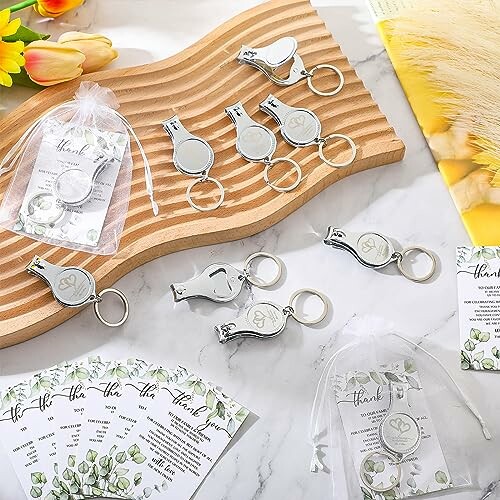 Set of wedding favor nail clippers with thank you cards and gift bags.