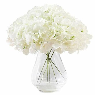 White hydrangea bouquet in a clear vase.